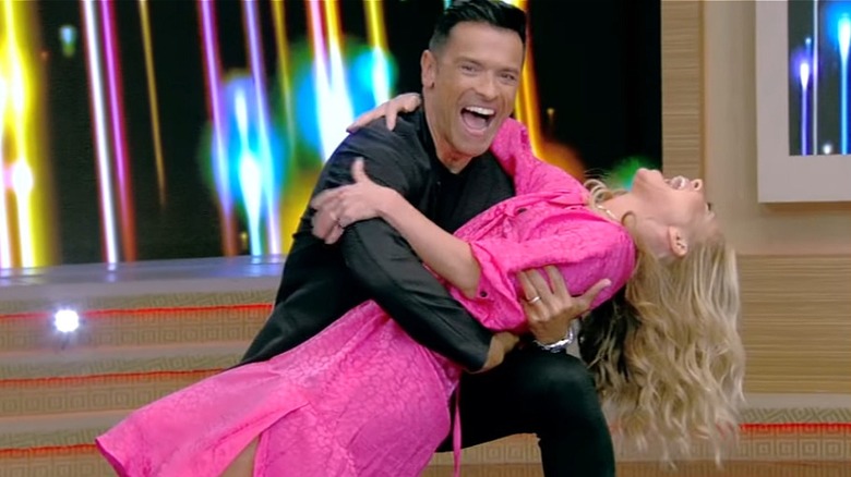 Kelly Ripa and Mark Consuelos dancing on "Live with Kelly and Mark" in 2023