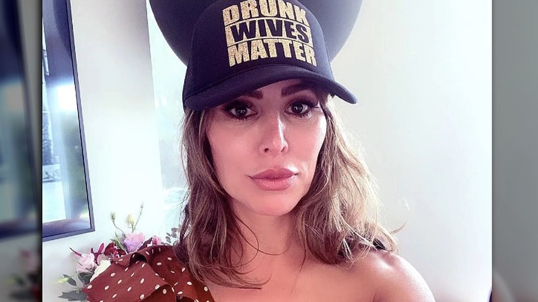 Kelly Dodd wearing her "Drunk Wives Matter" hat