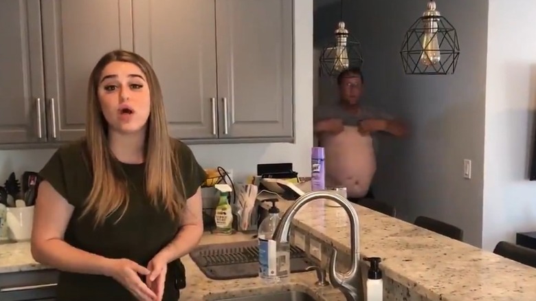 Jessica Lang and dad putting on shirt