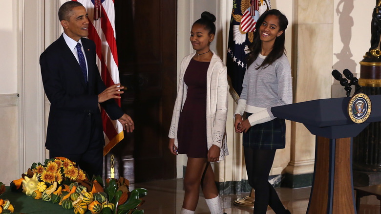 Sasha Obama wears one of the season's trendiest unisex bags