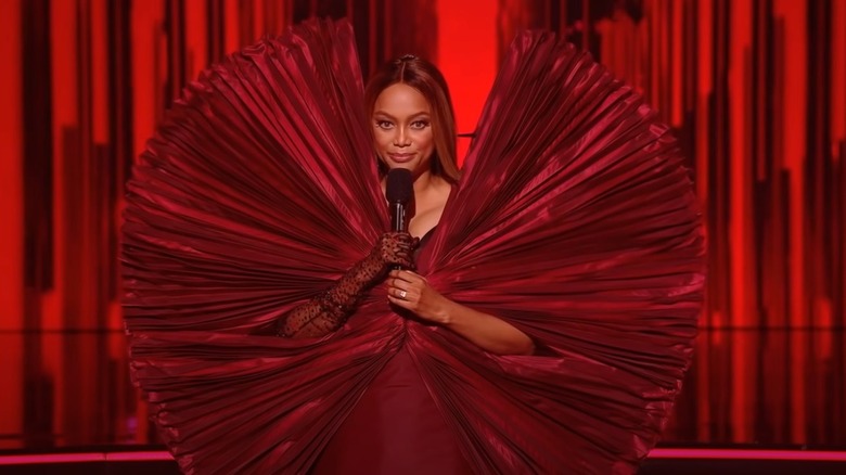 Tyra Banks red dress with huge collar