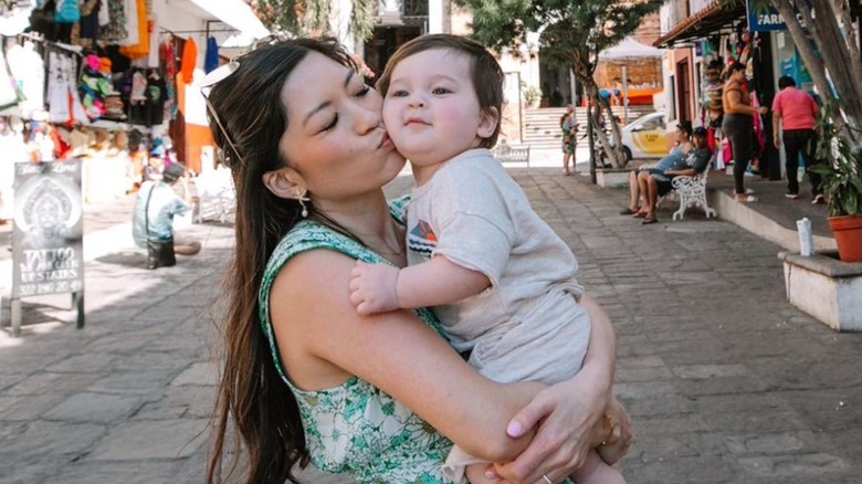 Christine Trans Ferguson posing with baby Asher