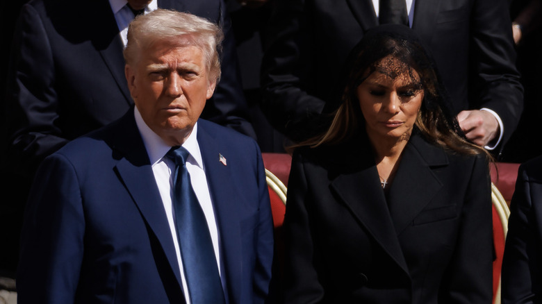 Donald Trump, dressed in blue, stares directly at the camera at Pope Francis' funeral.