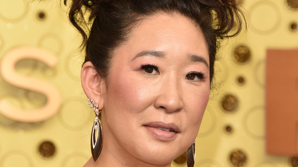 Sandra Oh posing at a red carpet event