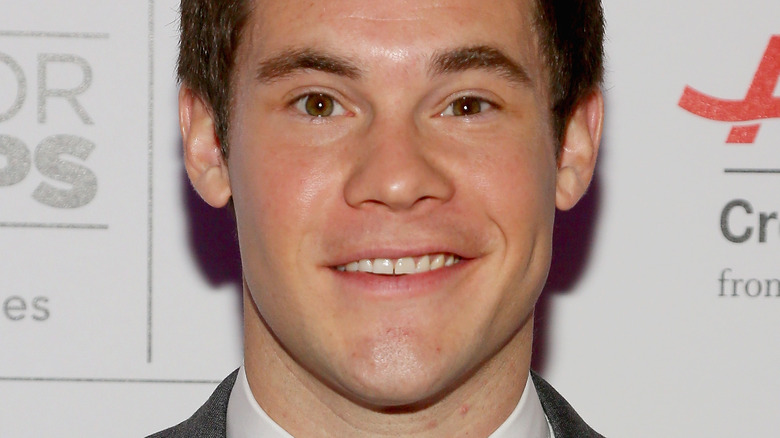 Adam Devine smiling at an awards show