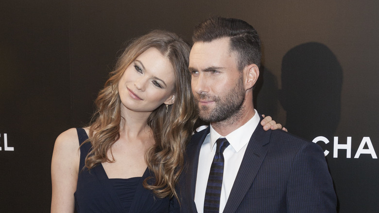 Behati Prinsloo leans on Adam Levine 