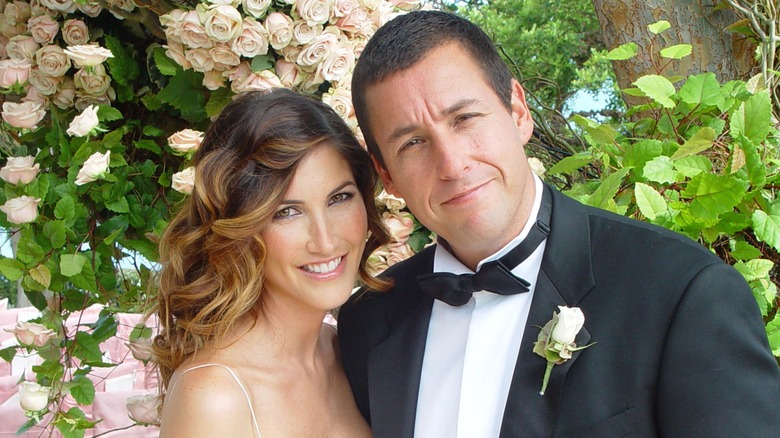 Jackie and Adam Sandler posing for photos at their wedding venue