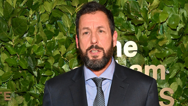 Adam Sandler posing with award