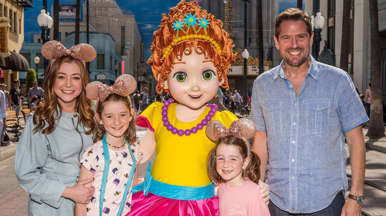 Alyson Hannigan and Alexis Denisof posing with kids