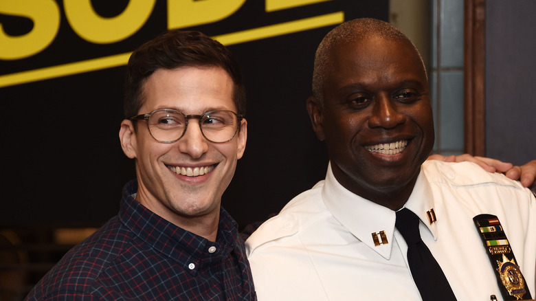 Andy Samberg and Andre Braugher grinning