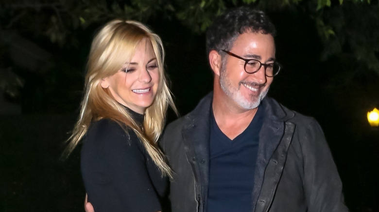 Anna Faris and Michael Barrett smiling and hugging