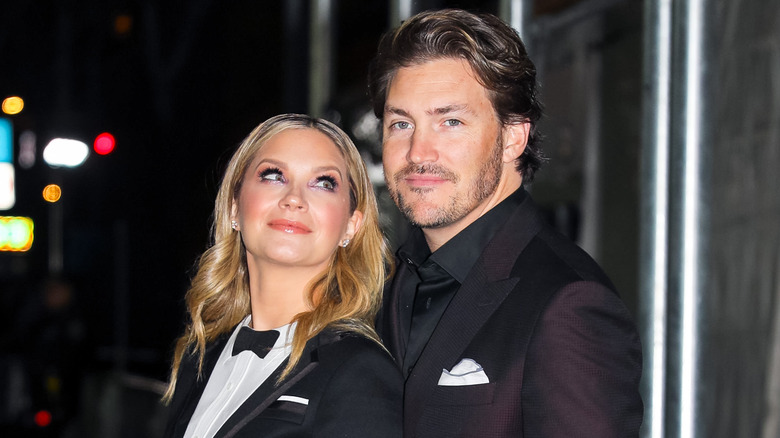 Vanessa Ray and Landon Beard wearing suits