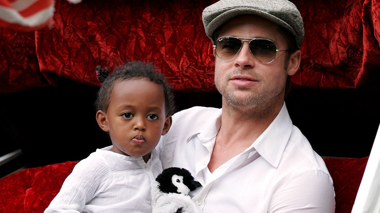 Brad Pitt holding Zahara as a toddler 