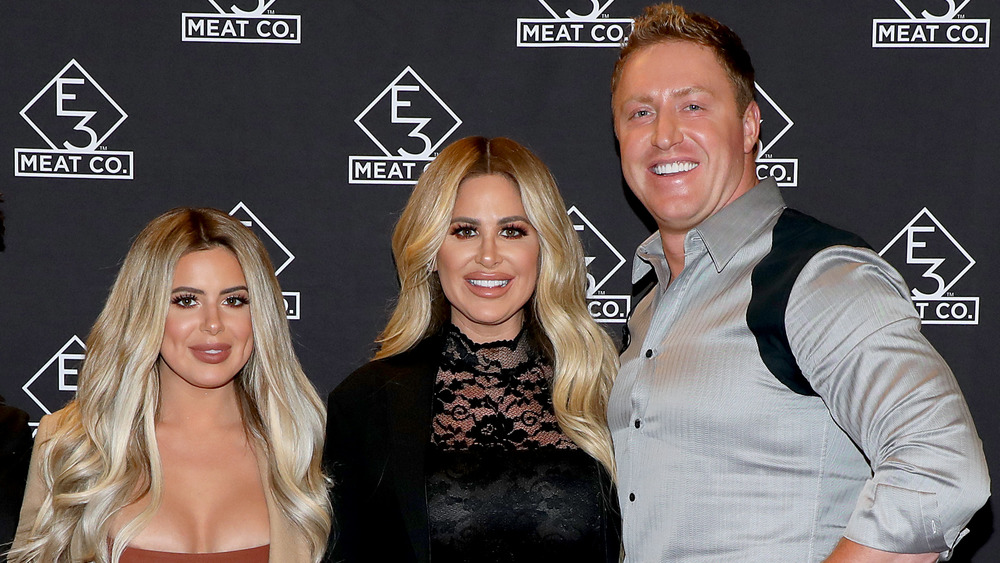 Kim, Kroy, and Brielle Biermann at an event