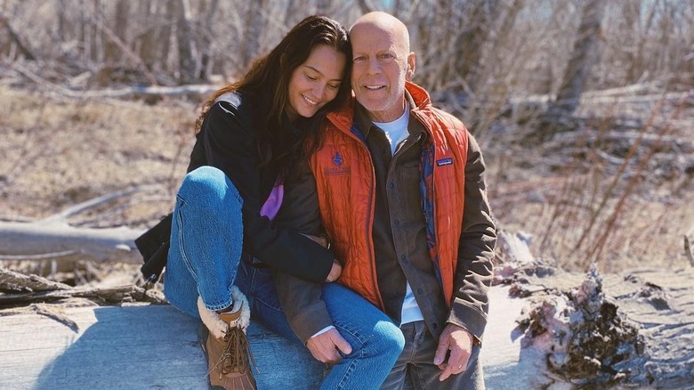 Emma Heming, Bruce Willis sitting on log