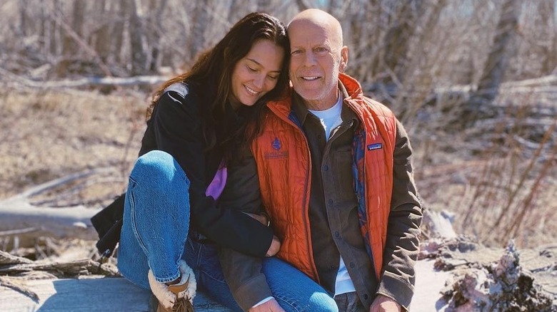 Emma Heming, Bruce Willis sitting on log