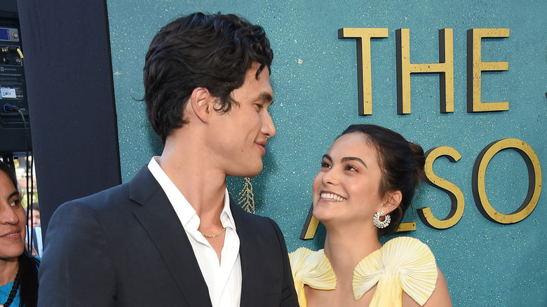 Camila Mendes and Charles Melton smiling at movie premiere