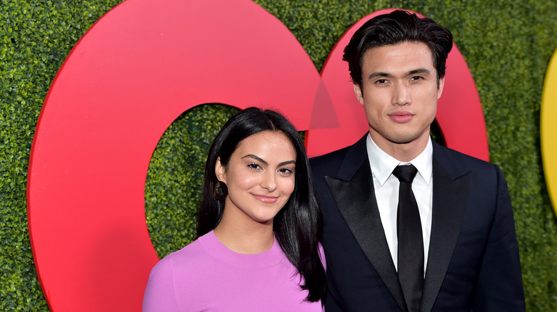 Camila Mendes and Charles Melton smiling at event
