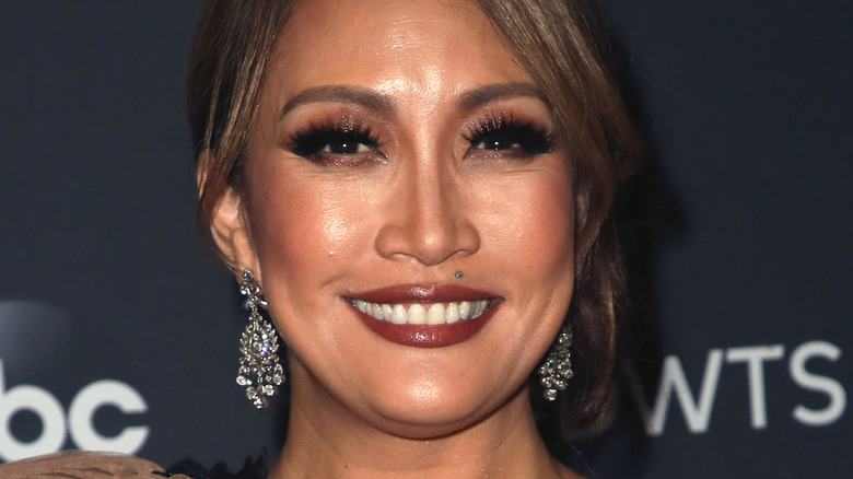 Carrie Ann Inaba with wide smile on the red carpet