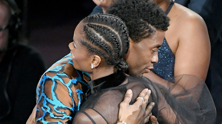 Chadwick Boseman and Letitia Wright hugging
