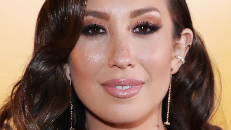 Cheryl Burke smiling and subtly squinting