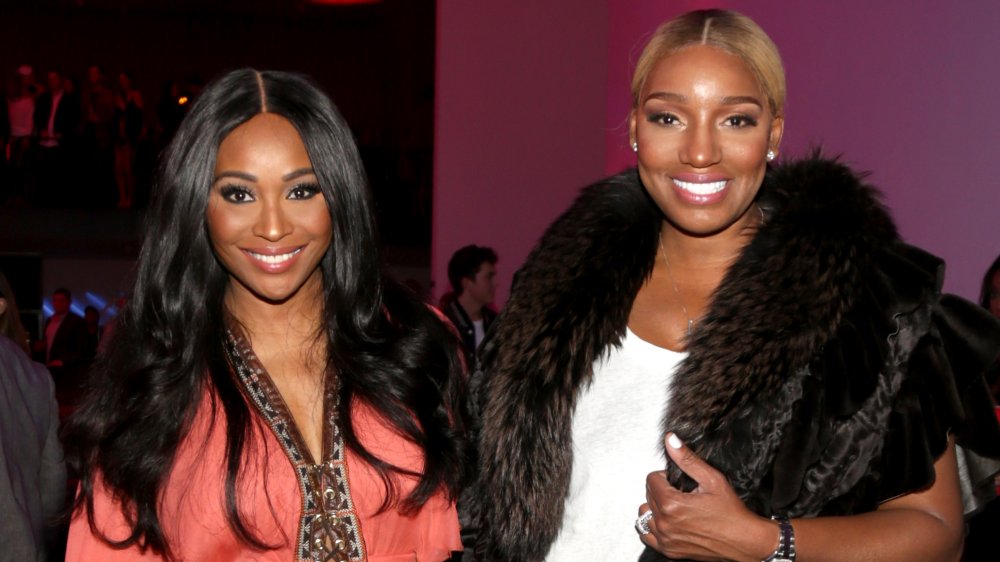 Cynthia Bailey and NeNe Leakes, smiling while posing arm in arm