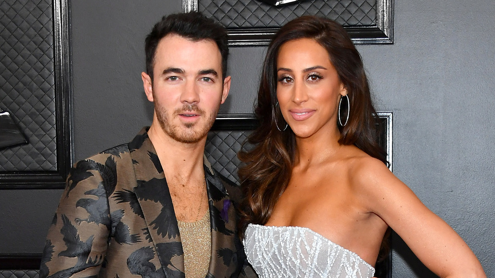 Kevin Jonas and Danielle Jonas posing arm-in-arm