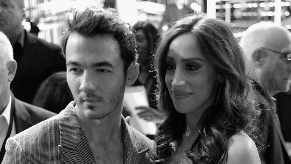 Kevin Jonas and Danielle Jonas posing arm-in-arm