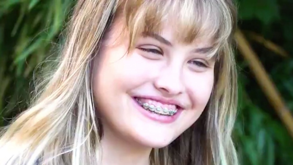 Dannielynn Birkhead in a plain blue t-shirt smiles while shooting for the 20/20 special