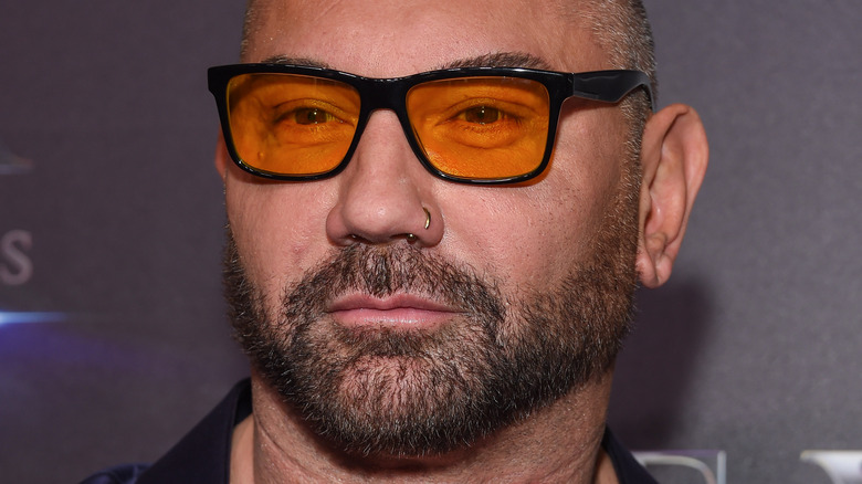 Dave Bautista looks on in sunglasses