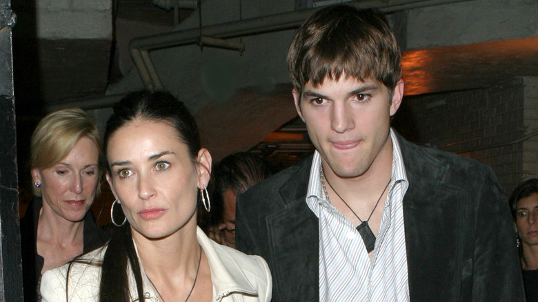 Demi Moore, Ashton Kutcher with somber expressions