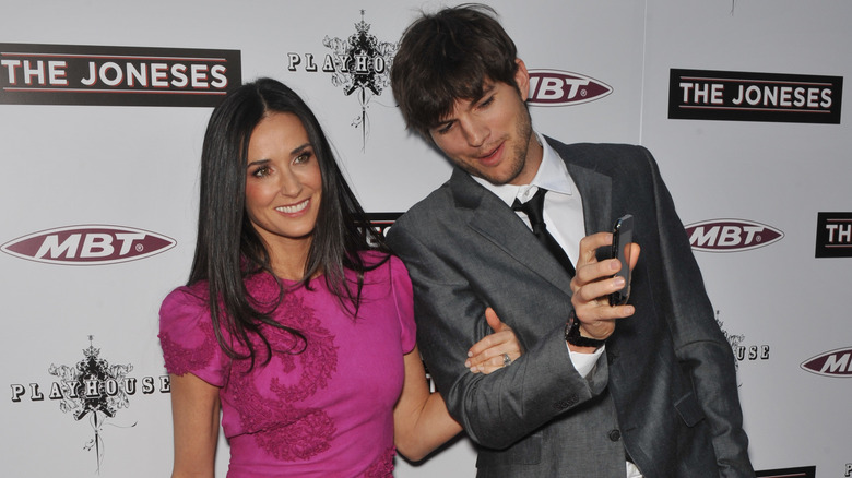 Ashton Kutcher taking photo of Demi Moore