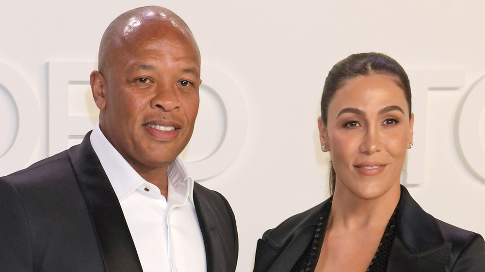 Dr. Dre and Nicole Young posing on the red carpet
