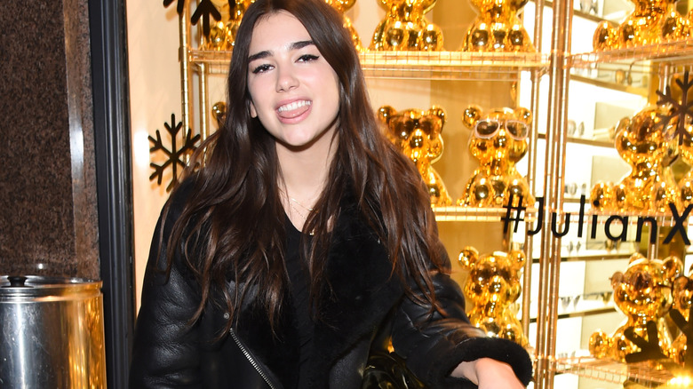 Dua Lipa smiling, tongue out