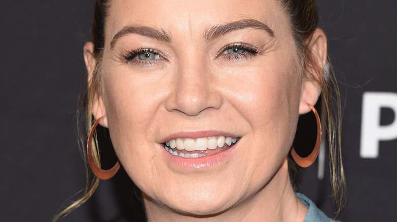 Ellen Pompeo poses in copper hoop earrings