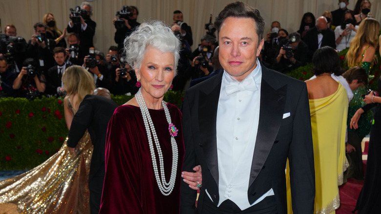 Elon Musk poses with Maye Musk posing