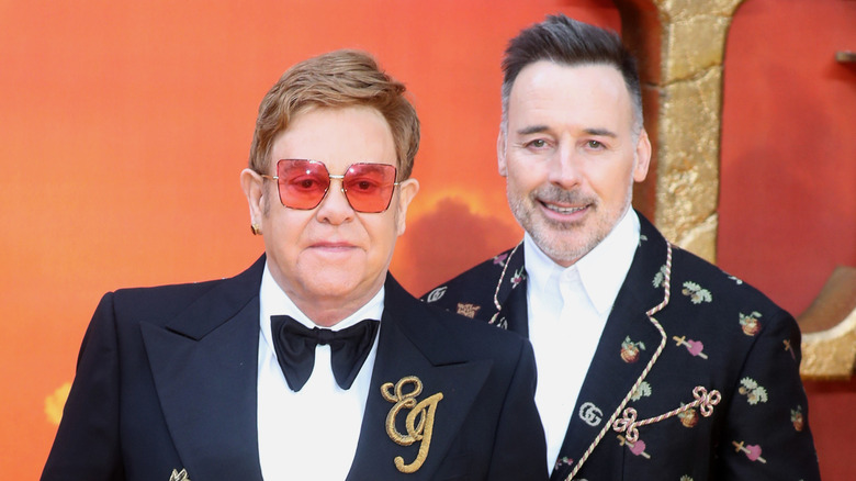 Elton John mad and David Furnish adorned suit