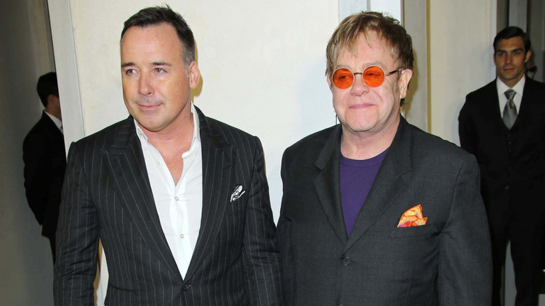 David Furnish and Elton John smirking