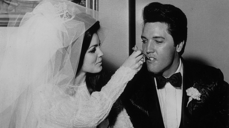 Priscilla feeds Elvis cake