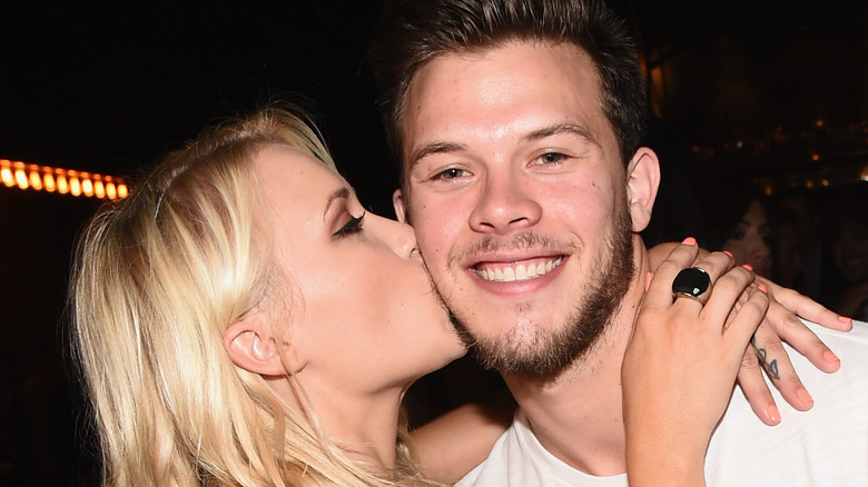 Emily Osment kissing Jimmy Tatro cheek