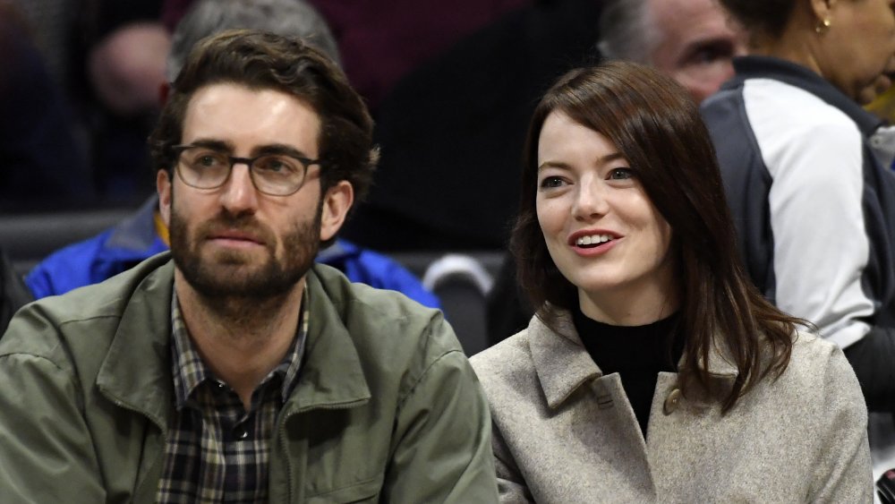 Dave McCary and Emma Stone at a basketball game