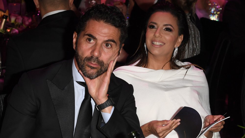 Jose Baston and Eva Longoria seated at event