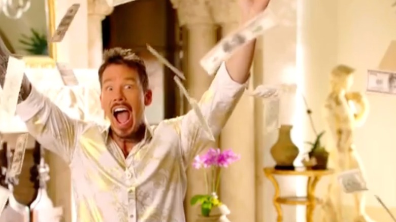 David Bromstad surrounded by cash in a My Lottery Dream Home promo