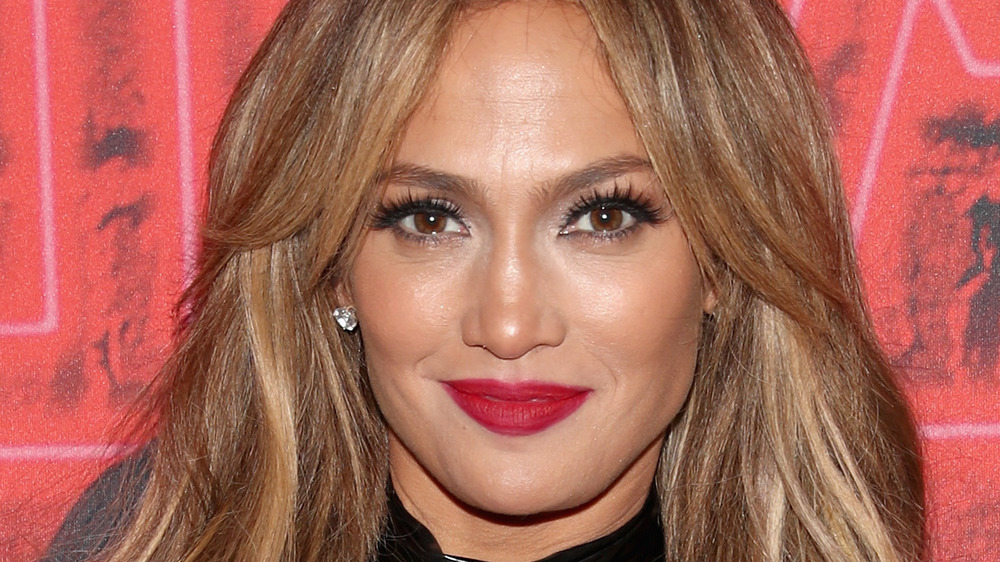 Jennifer Lopez wearing red lipstick at an event