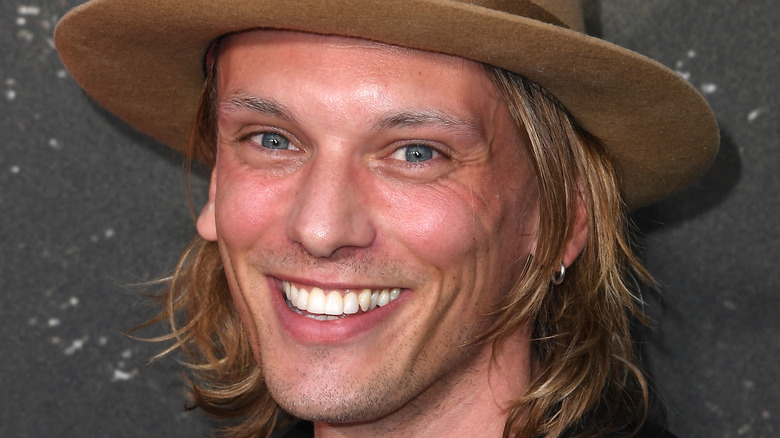 Jamie Campbell Bower hat and smile