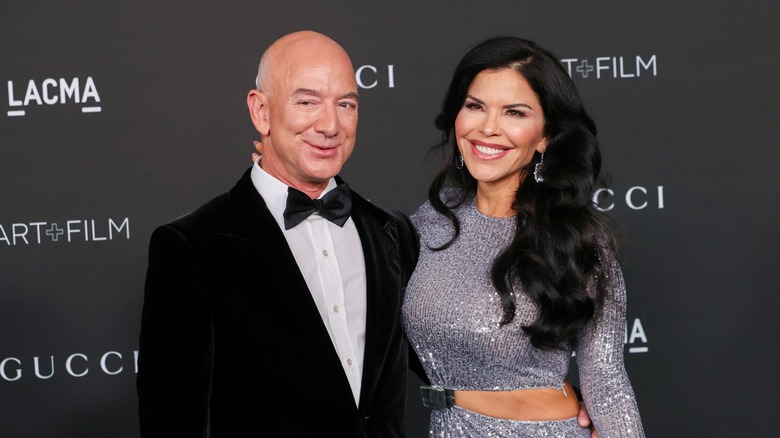 Lauren Sanchez smiles as her arm is gently wrapped around Amazon billionaire Jeff Bezos' neck.