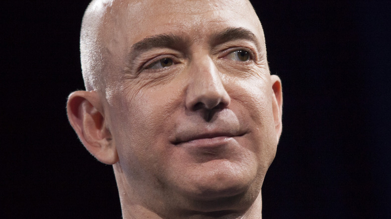 Jeff Bezos smiles on stage