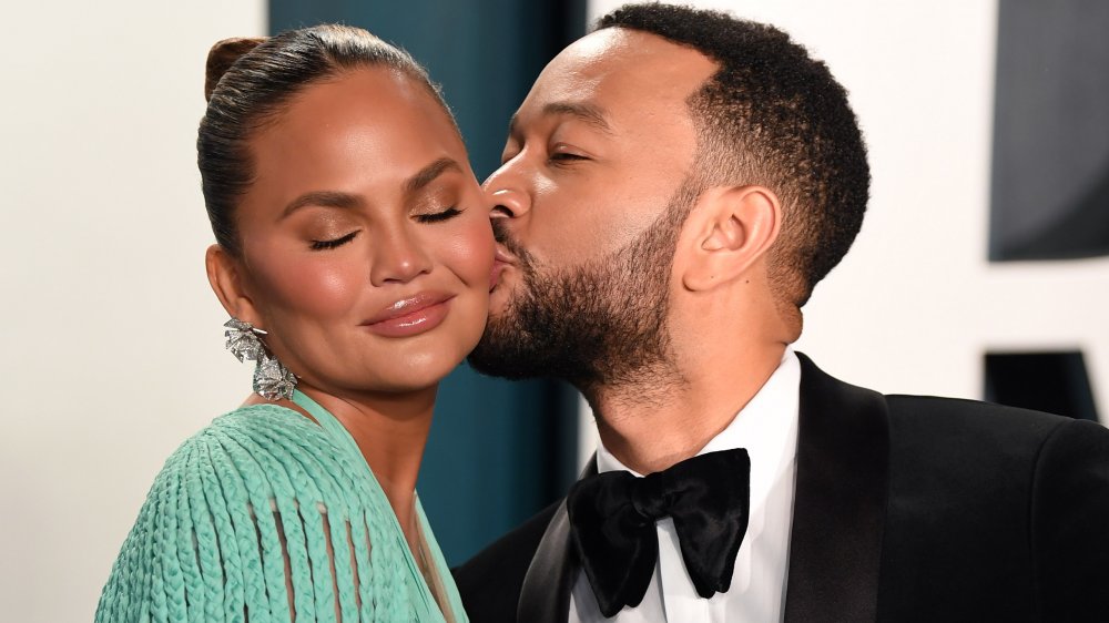 John Legend kissing Chrissy Teigen's cheek