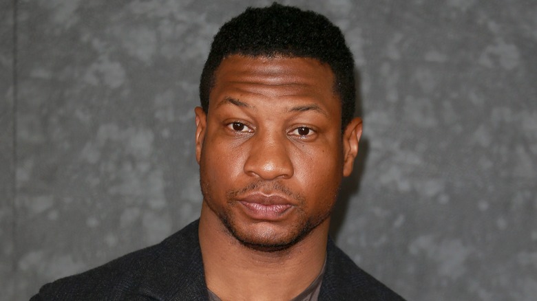 Jonathan Majors looking stern