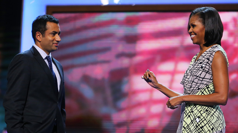 Kal Penn and Michelle Obama on stage for rally 